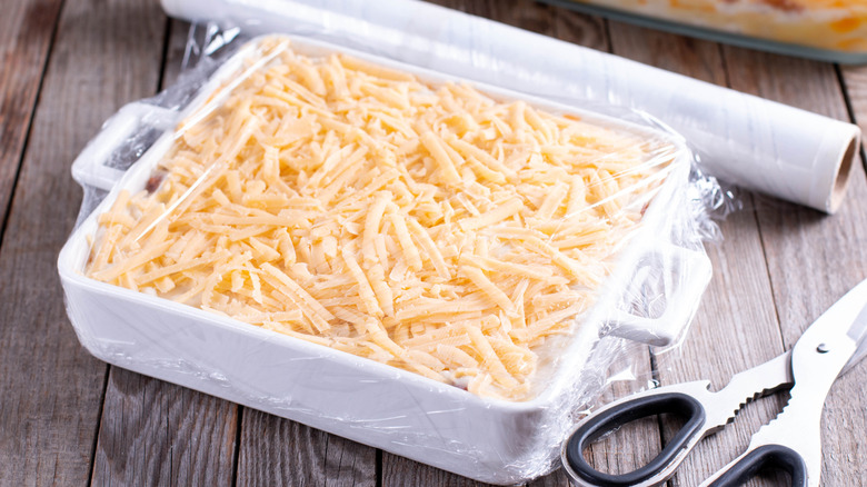 Prepared lasagna wrapped in plastic