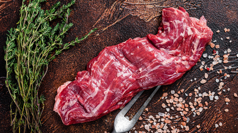 raw skirt steak with salt and herbs