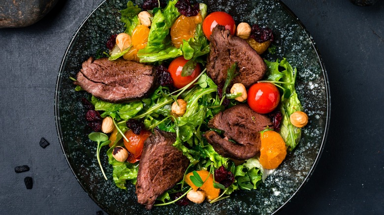 Top-down view of steak salad with arugula