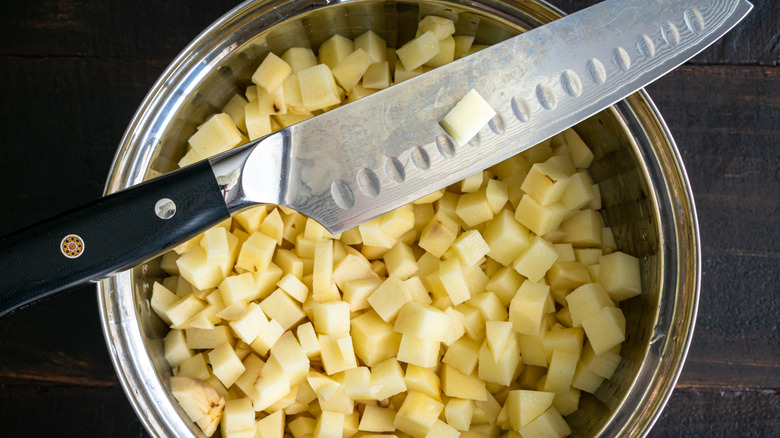 cubed potatoes and a knife 