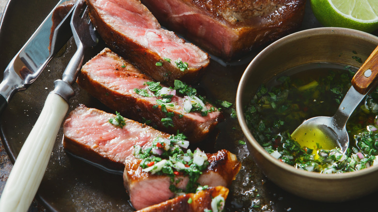 grilled steak slices with chimichurri sauce