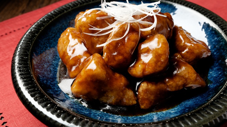 Close-up of cooked pork coated in sauce 