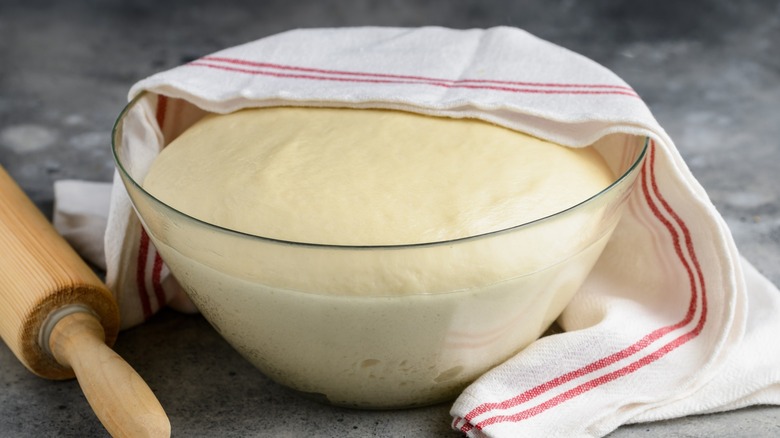 Dough rising in glass bowl