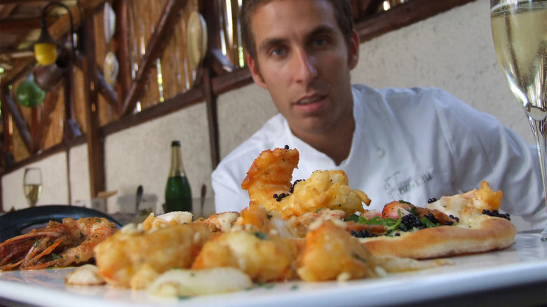 renato viola posing with pizza