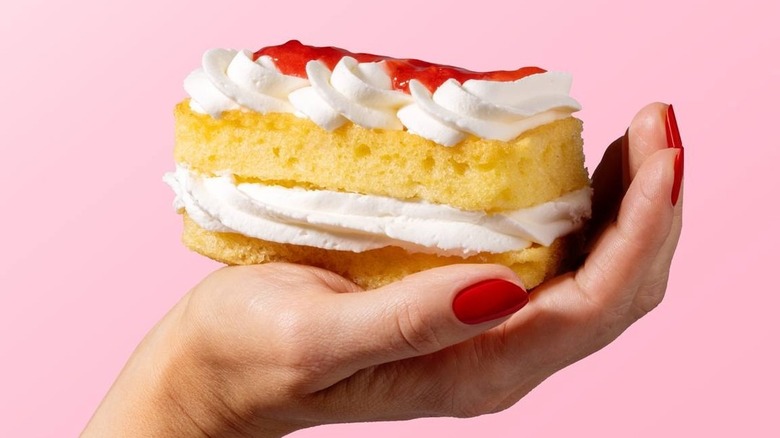 hand holding piece of Strawberry Shortcake