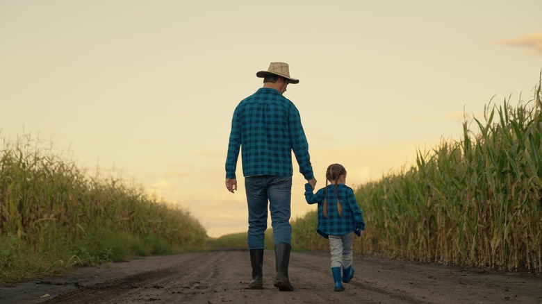 Farmer parent and child walking together