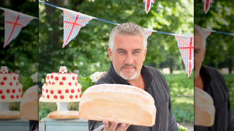 Paul Hollywood on Great British Bake Off holding a loaf