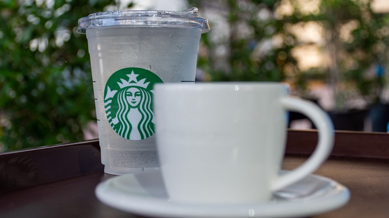 A Starbucks cup of water and mug