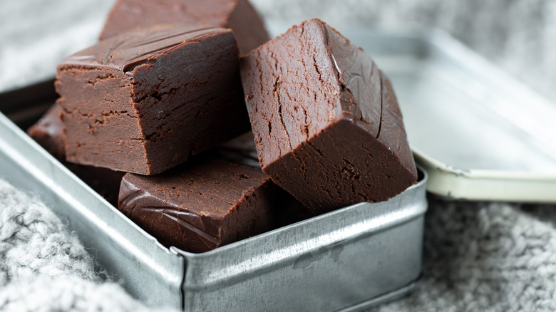 Squares of chocolate fudge in silver tin