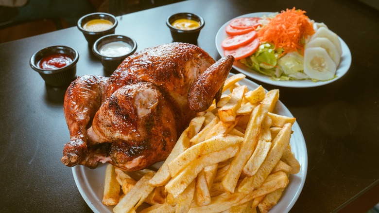 pollo a la brasa with fries and sauces