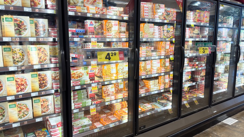 fully stocked frozen dinner cooler at the grocery store