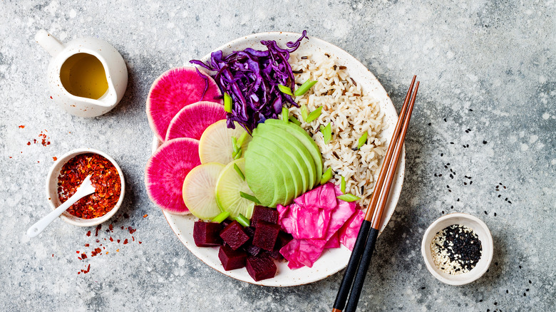 Poke bowl with beets, radishes, cabbage, and avocado