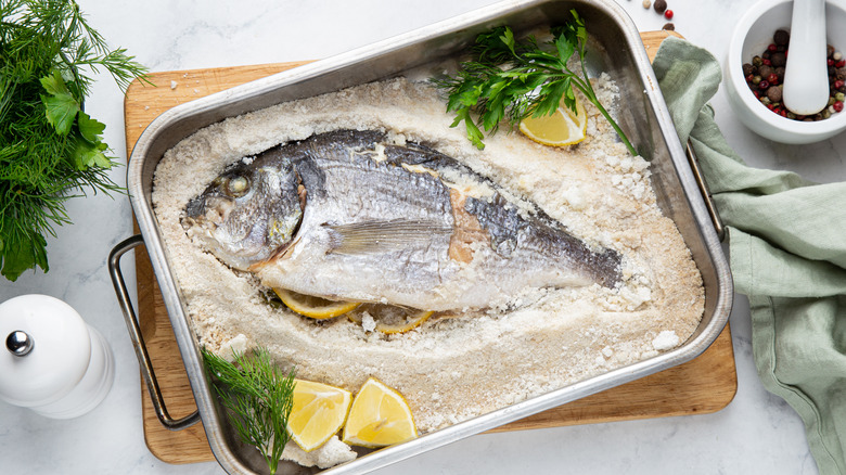 fish in baking dish on layer of salt