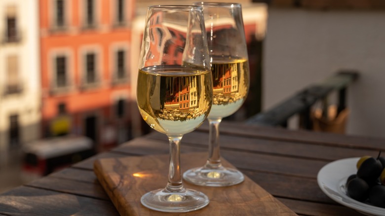 Two glasses of sherry on a wooden board in Spain