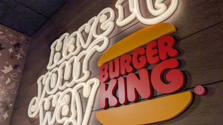 The Burger King Have It Your Way sign on a wooden wall