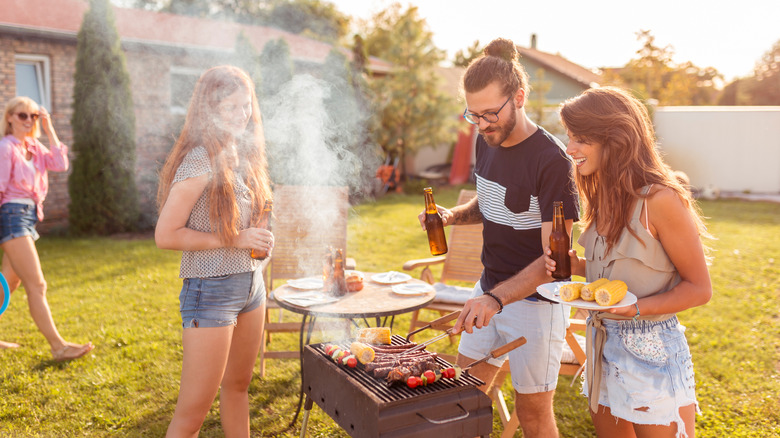 young people at a BBQ with beer