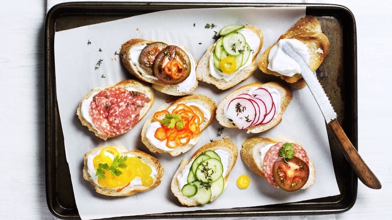 Crostini on a pan with different toppings