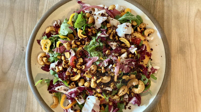 Salad with leaves, onion, cheese and nuts