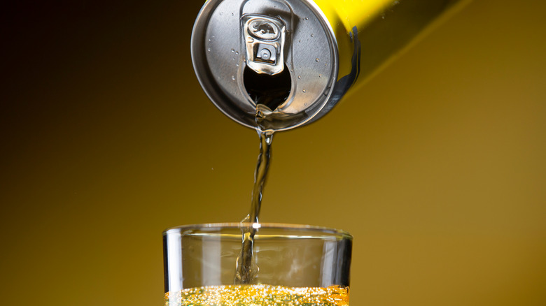 Canned soda poured into glass