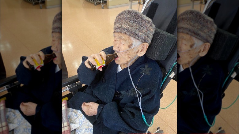 Tane Kanaka drinks soda with hat