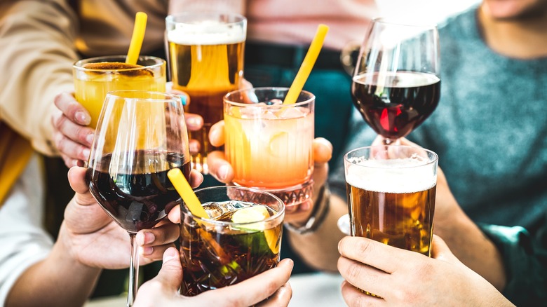 friends cheersing multiple drinks