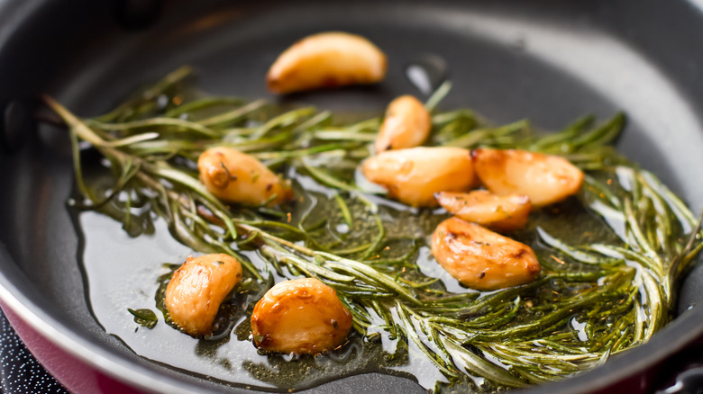 garlic in pan with rosemary