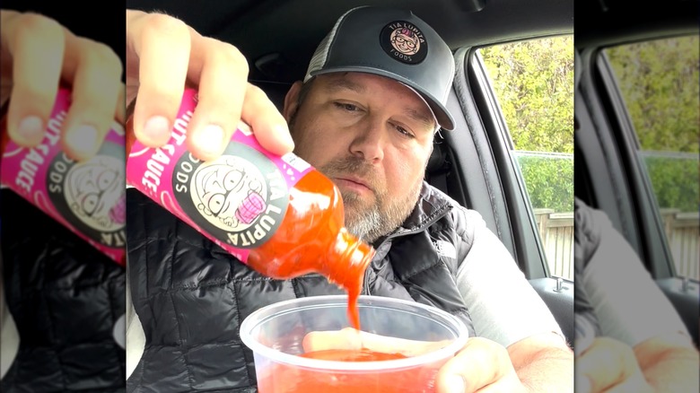 Hector Saldivar pouring hot sauce