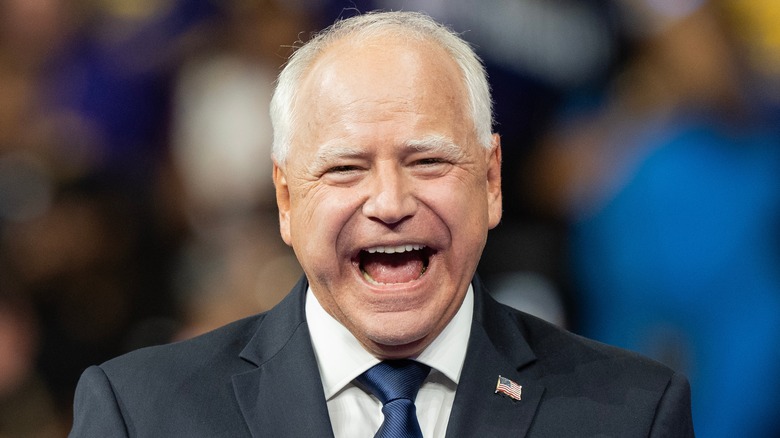 Tim Walz smiling at a political rally