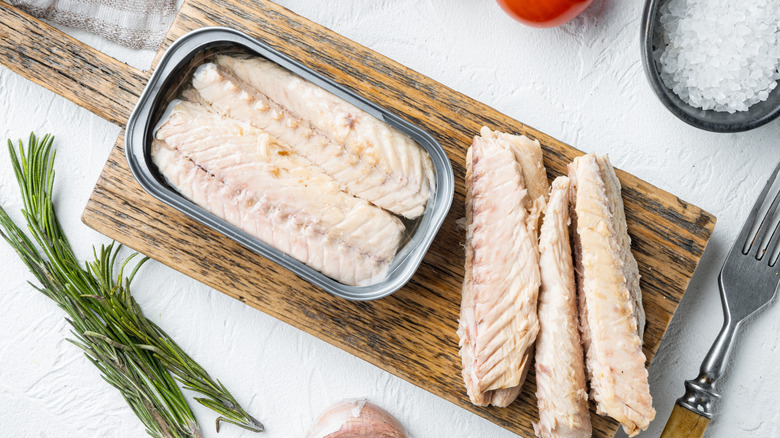 Canned mackerel filets on wood board