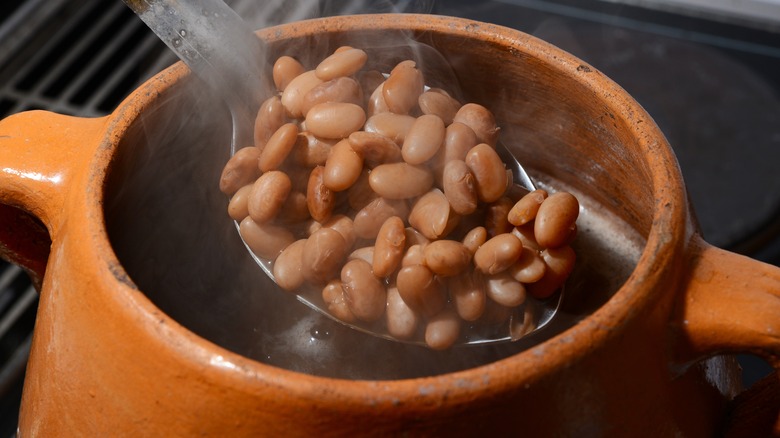 Clay pot with steaming pinto beans