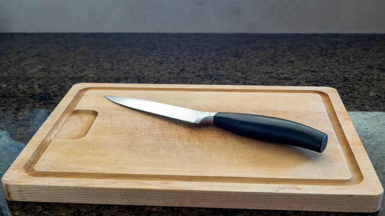 Paring knife on a wooden cutting board