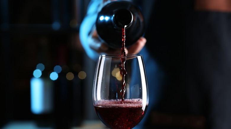 pouring red wine in glass