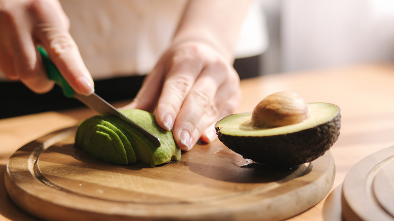 woman slicing avocado 