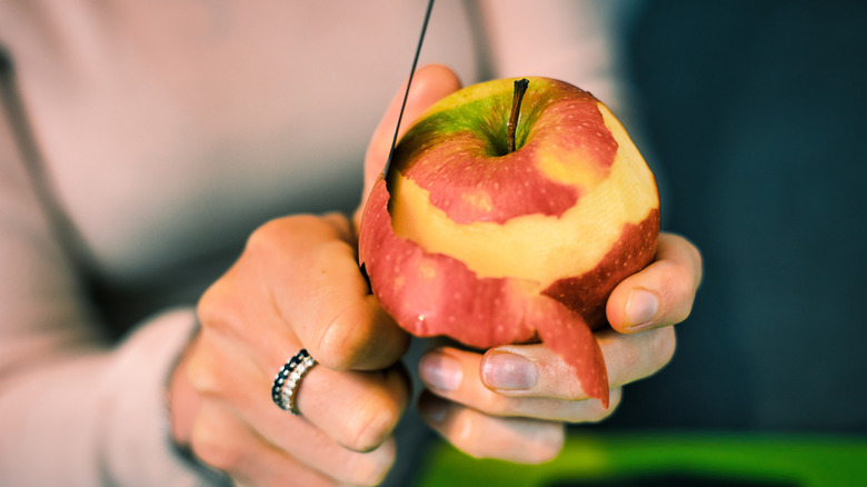 Person peeling apples