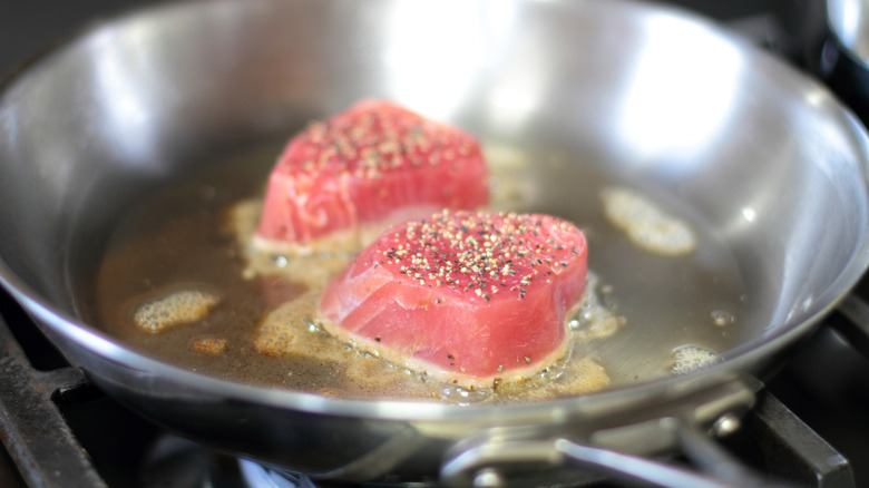 tuna steak searing in skillet