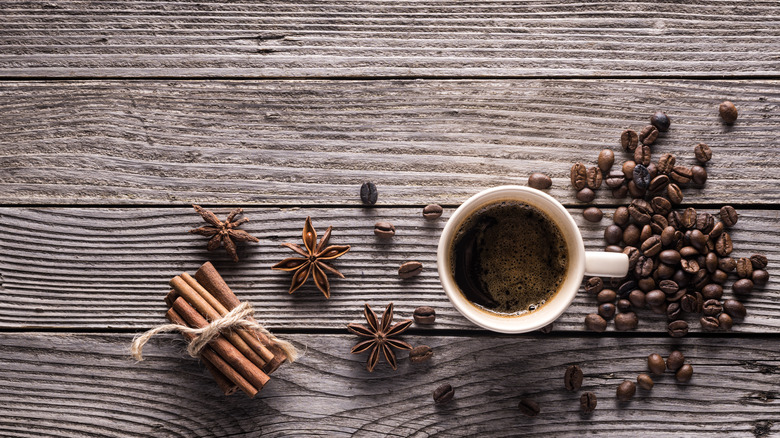 Spices and coffee beans on wood