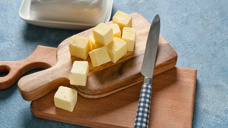 Cubed butter on wood board