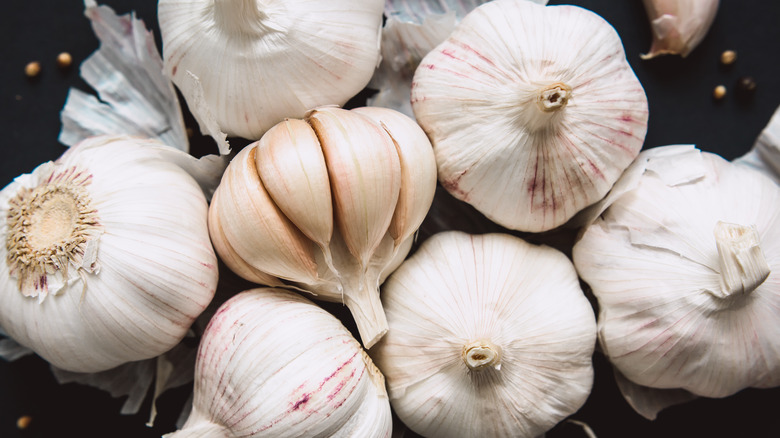 garlic cloves on black background