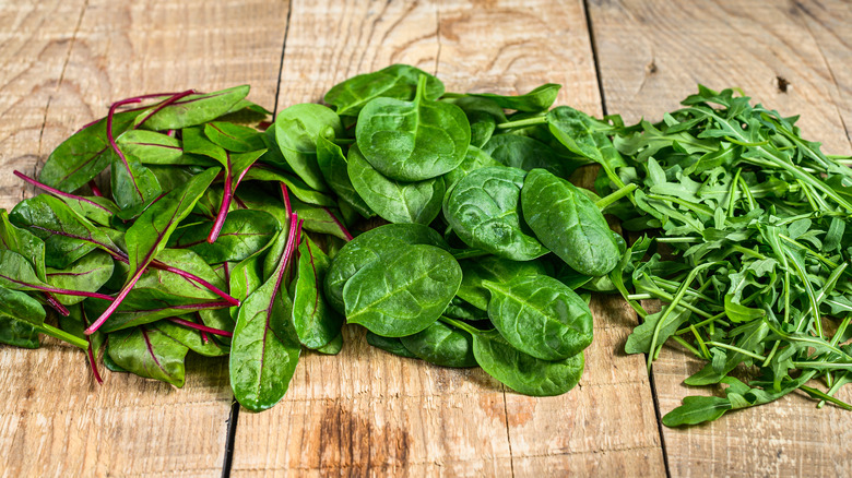 spinach and arugula on wood