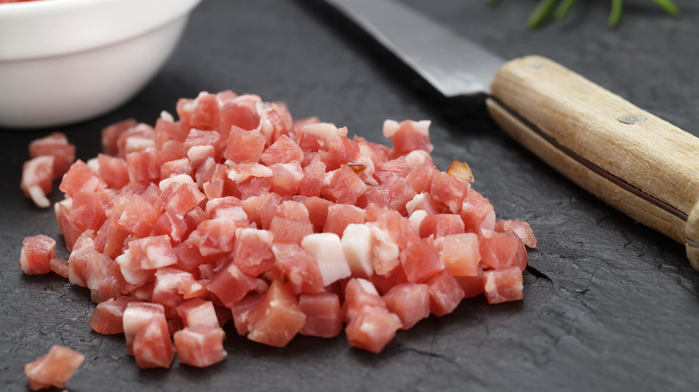 diced Italian pancetta with knife