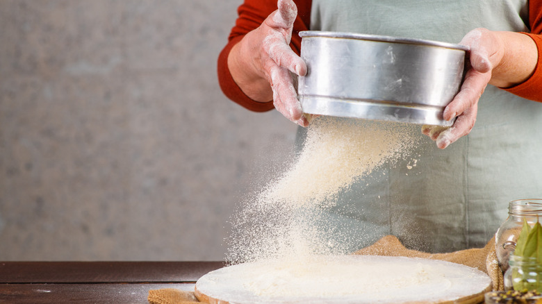 Using sieve to dust flour