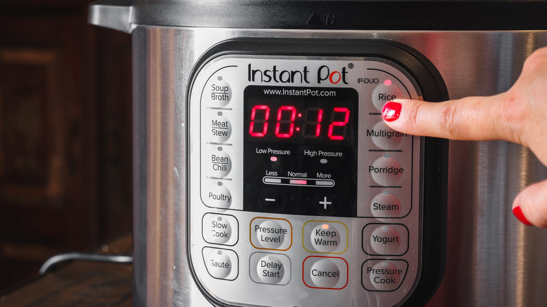 Woman pressing Instant Pot button