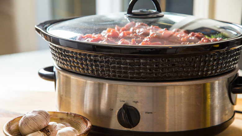 slow cooker and garlic in dish