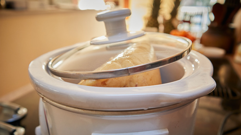 Meat in slow cooker with lid