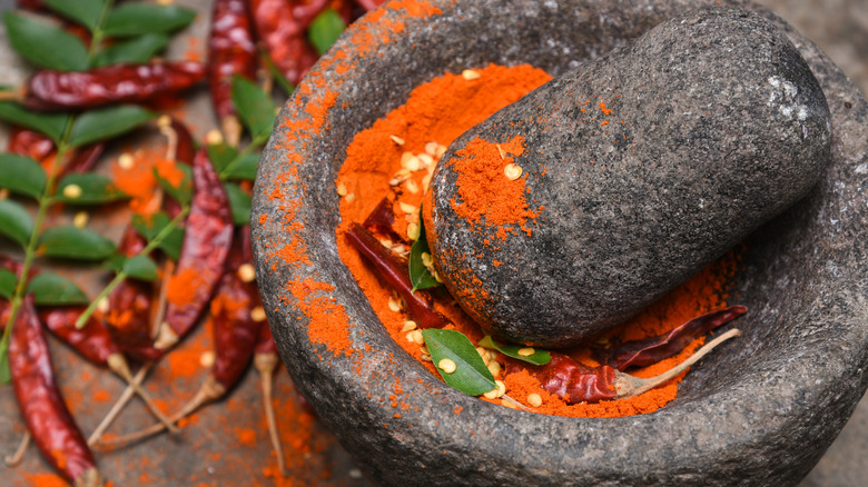 Powdered spices in a mortar and pestle 