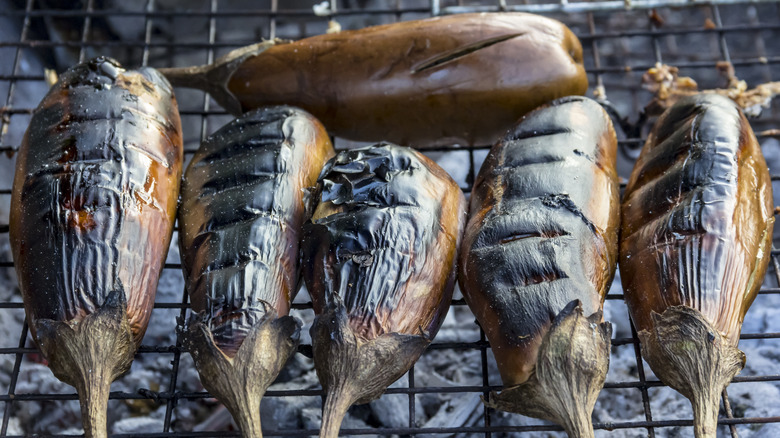 Charred eggplants on grill