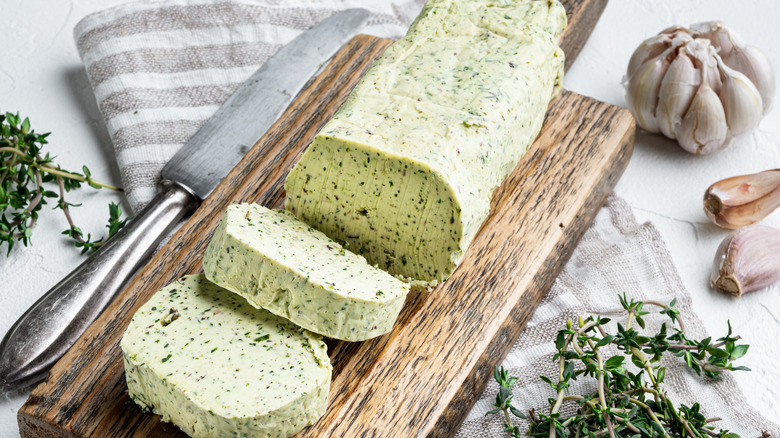 A log of compound butter with herbs