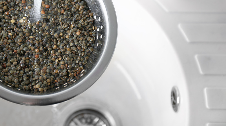 Rinsing lentils under a tap