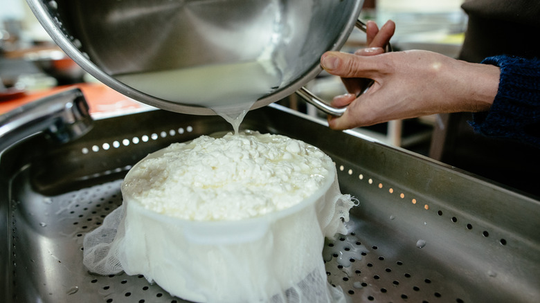 Pouring curdled milk into bowl