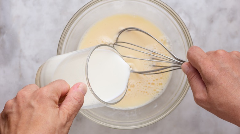 Milk pouring into bowl